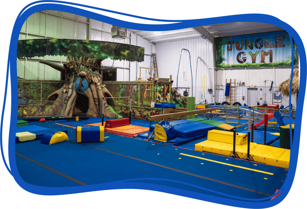 The inside of the "JUNGLE GYM" is shown with colorful mats and equipment appropriate for pre-schoolers.